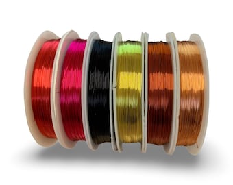 May include: Six spools of colorful wire, each wound around a white plastic spool. The colors are red, pink, black, yellow, orange, and copper.