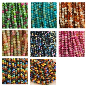 May include: Assortment of agate gemstone beads in various colours, including green, blue, orange, pink, and black. The beads are round and have a smooth, polished finish.