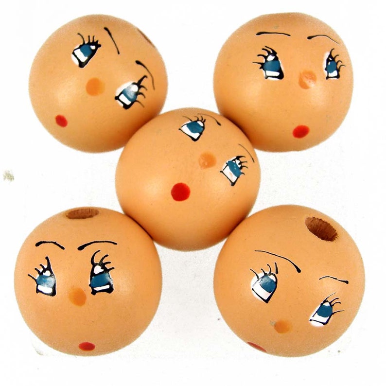 wooden doll heads with faces