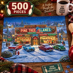 May include: A 500-piece jigsaw puzzle featuring a snowy scene of Pine Tree Lanes candlepin bowling alley at night. The image shows a brick building with festive lights, vintage cars, and people. A white mug reads EAT BOWL PUZZLE REPEAT.