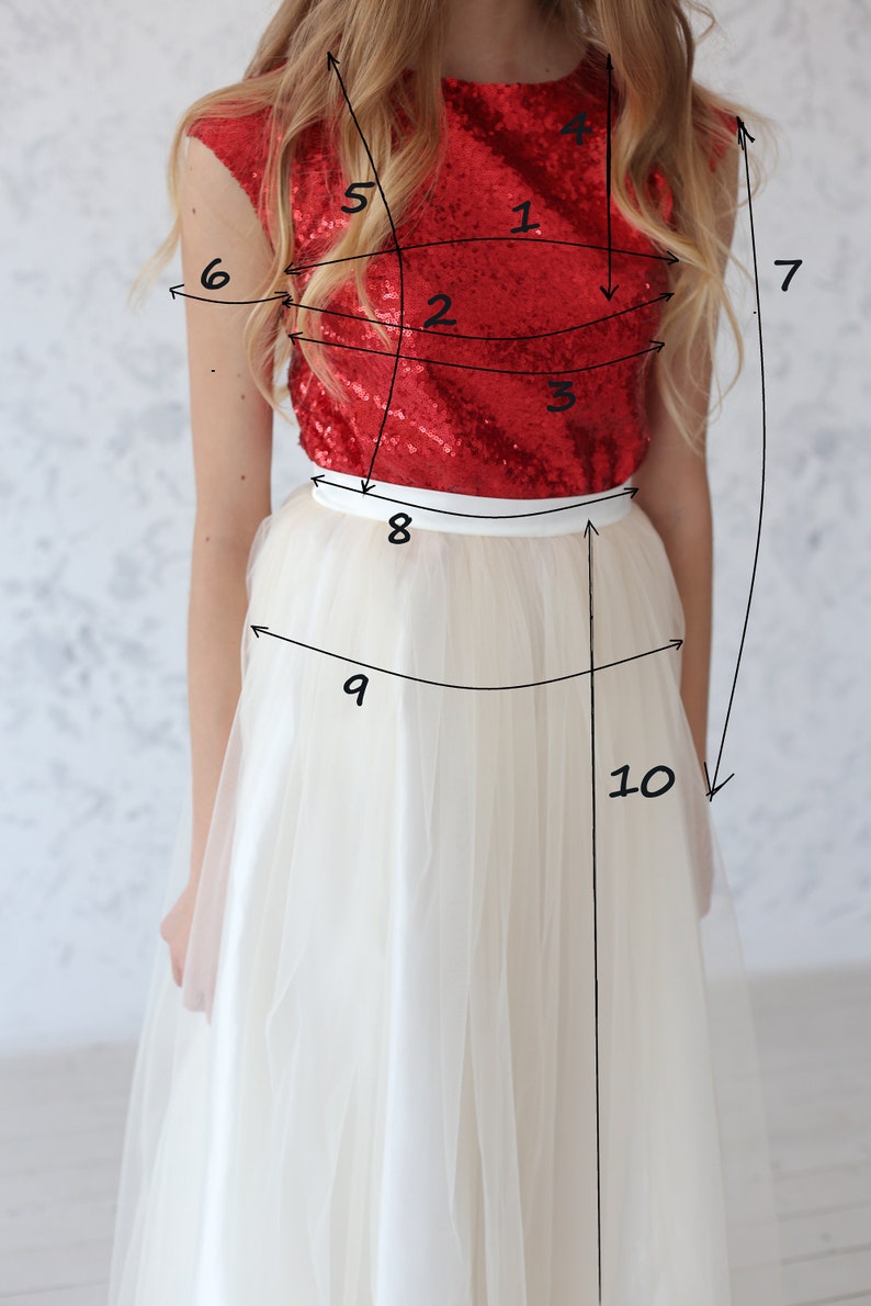 May include: A woman wearing a red sequined top and a white tulle skirt. The top has a scoop neck and sleeveless design. The skirt is full and flowing. The image is labeled with numbers 1 through 10, indicating different measurements.