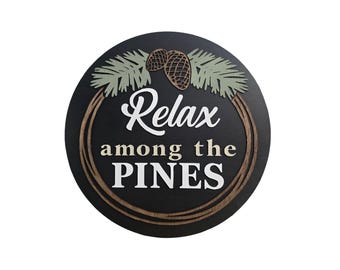 Relax Among the Pines Sign – 3D Wooden Round Rustic Cabin Wall Art with Pinecone Design
