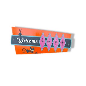 May include: A retro-style welcome sign with an orange background and a teal border. The sign features the word "Welcome" in white script, black cat silhouettes, and pink diamond shapes with starburst details. A decorative piece for a home.