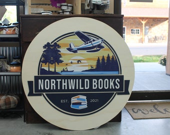 Book Store Small Business Logo Custom Round Sign Printed In Color Raised Lettering Sunset Airplane Commerical Store Front Signage