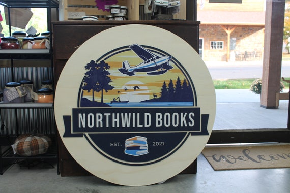 Book Store Small Business Logo Custom Round Sign Printed In Color Raised Lettering Sunset Airplane Commerical Store Front Signage