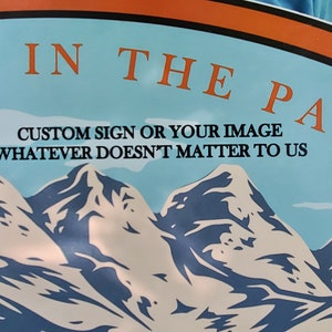 May include: A blue and white sign with the text "Steps in the Past" and the text "Custom sign or your image whatever doesn't matter to us". The sign features a graphic of three mountains.