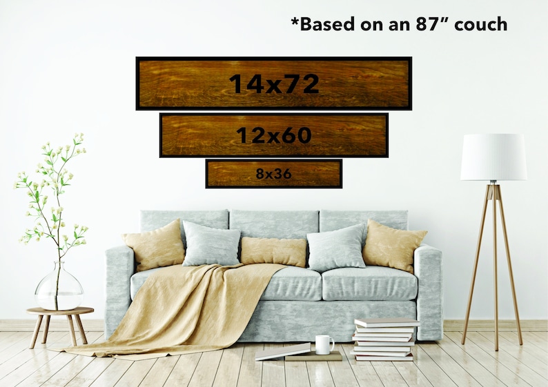 May include: Three wooden signs with black frames and white text showing different sizes of art prints, 14x72, 12x60, and 8x36. The signs are displayed on a white wall above a light gray couch with a tan throw blanket. *Based on an 87" couch*