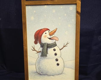 Snowman eating snow cartoon printed on wood sign for holiday decoration and vignette