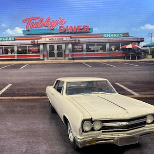 May include: A white classic car is parked in front of Tubby's Diner. The diner has a red and white sign that says "Tubby's Diner" and "Burgers" and "Shakes". The sky is blue with some clouds.