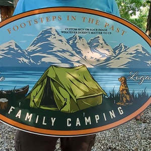 May include: Oval-shaped sign with a mountain scene, a tent, a dog, and the text "FootSteps in the Past", "Custom Sign or Your Image", "Whatever Doesn't Matter to Us", "Lake", "Logan", and "Family Camping".