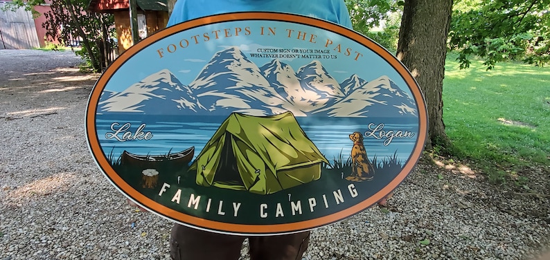 May include: Oval-shaped sign with a mountain scene, a tent, a dog, and the text "FootSteps in the Past", "Custom Sign or Your Image", "Whatever Doesn't Matter to Us", "Lake", "Logan", and "Family Camping".