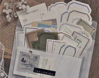 May include: A clear plastic envelope filled with various decorative paper labels. The labels are in different shapes and sizes, with some featuring a vintage aesthetic. The labels are printed with a variety of designs, including floral patterns, geometric shapes, and text.