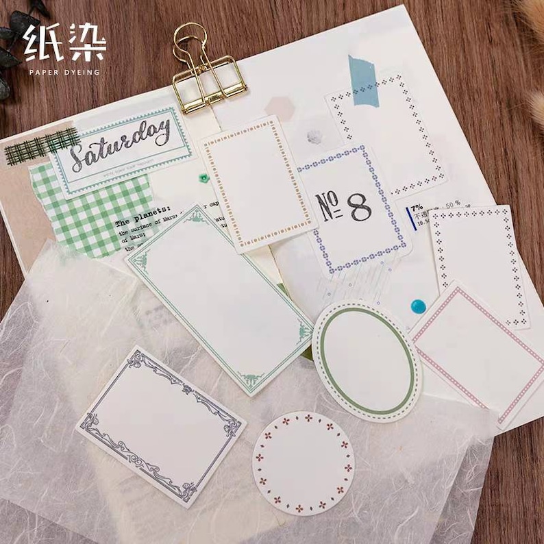 May include: A collection of decorative paper frames with various designs and borders. The frames are in different sizes and shapes, including circles, ovals, and rectangles. Some frames have a simple border, while others have more intricate designs. The frames are on a white background.
