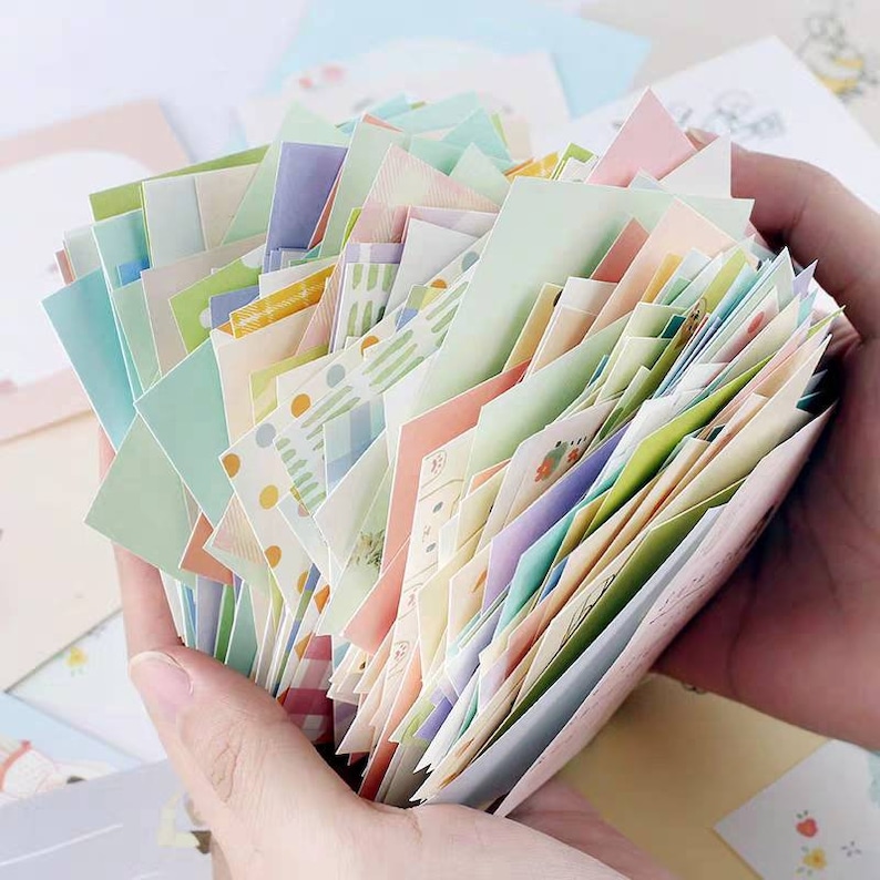 May include: A stack of colorful patterned paper squares, perfect for scrapbooking, journaling, or card making.