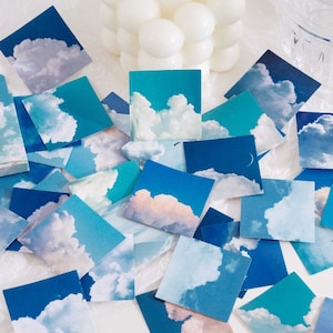 May include: A set of blue and white cloud stickers with the text "晴空 云朵" in Chinese characters. The stickers are square and feature different cloud formations against a blue sky background.