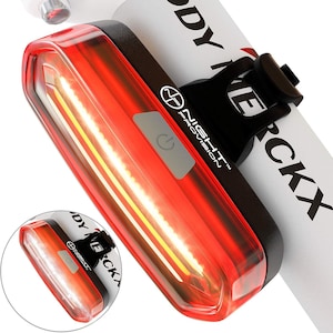 May include: A red bicycle tail light with a white LED strip and a black mount. The light has a power button and the text "NIGHT PROVISION" is printed on the side.