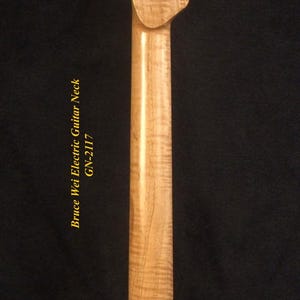 May include: A light-colored, unfinished electric guitar neck with a headstock featuring six tuning peg holes. The neck has a smooth, glossy finish and the text "Bruce Wei Electric Guitar Neck GW-2117".