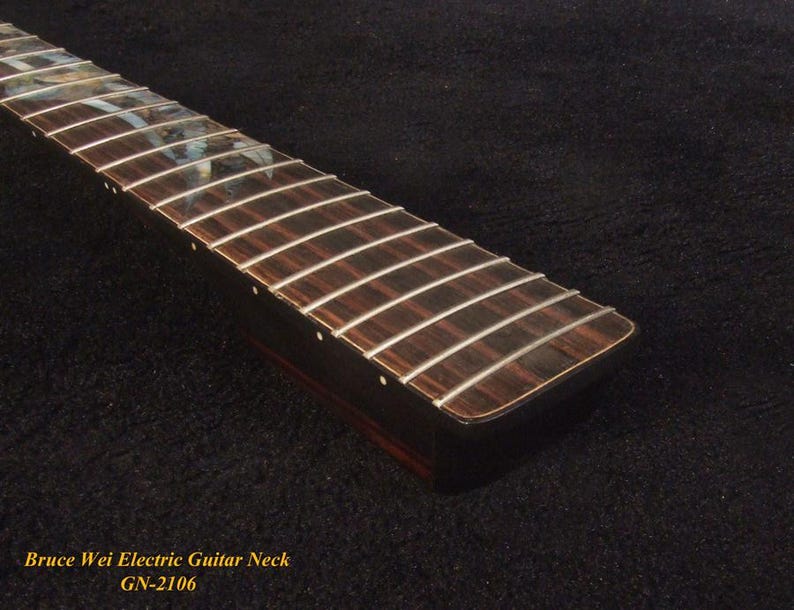 May include: Close-up of a guitar neck with silver frets and a dark wood fretboard. The text "Bruce Wei Electric Guitar Neck GN-2106" is visible at the bottom. The neck has a smooth, polished finish.