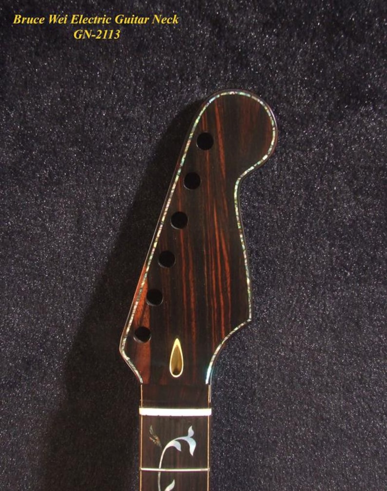 May include: Close-up of an electric guitar neck with a dark wood grain finish. The headstock has six tuning peg holes and is outlined with a pearlescent inlay. The text "Bruce Wei Electric Guitar Neck GN-2113" is visible.