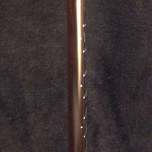 May include: A dark brown electric guitar neck featuring a smooth fretboard with white dot position markers along the side. The text Bruce Wei Electric Guitar Neck GN-2127 is printed in yellow on the left side of the guitar neck component.