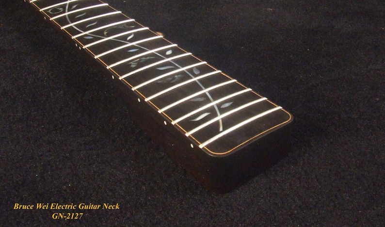 May include: A dark wood electric guitar neck featuring a fretboard with silver-toned metal frets and an intricate vine-like inlay pattern made of iridescent shell material. The text Bruce Wei Electric Guitar Neck GN-2127 is printed in yellow.