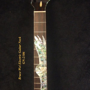 May include: A dark brown electric guitar neck with a decorative inlay. The neck has a headstock with tuning pegs and a fretboard with inlaid mother-of-pearl designs. The text "Bruce Wei Electric Guitar Neck GN-2106" is visible.