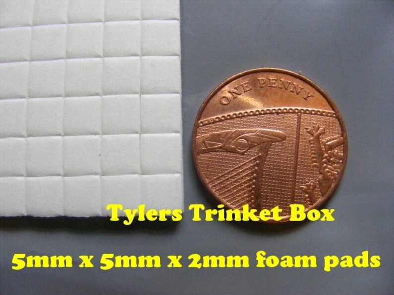 May include: A sheet of white foam pads with a grid pattern. The pads are 5mm x 5mm x 2mm in size. A British penny coin is included for scale. The text "Tylers Trinket Box" is printed below the foam pads.