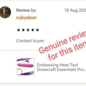 May include: A pink heat tool with a black handle and a silver tip. The tool is on a purple surface with a pair of silver scissors. The text "Embossing Heat Tool Dovecraft Essentials Pro..." is below the image.