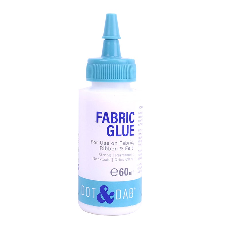 May include: A white bottle of fabric glue with a blue cap and label. The label says "FABRIC GLUE" and "DOT & DAB". It is for use on fabric, ribbon, and felt. It is strong, permanent, non-toxic, and dries clear. The bottle contains 60 ml of glue.