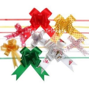 May include: Assortment of colourful gift bows in various patterns and colours, including red, green, yellow, white, and pink. The bows are made of ribbon and are tied in a variety of styles. The text "Tyler's Trinkets" is visible in the image.
