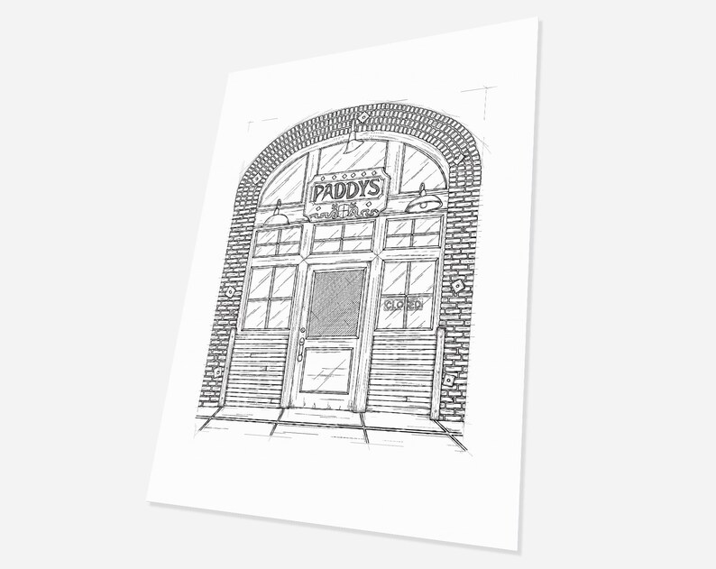 May include: A black and white line drawing of a brick building with an arched doorway. The doorway has a sign that reads "Paddy's Pub" and a closed sign on the door.