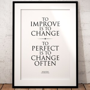 May include: Black and white typography print with the quote "To improve is to change. To perfect is to change often." by Winston Churchill.