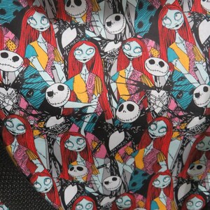 May include: A black and white fabric with a repeating pattern of Jack Skellington and Sally from the Nightmare Before Christmas. The characters are in various poses and expressions, with Sally's red hair and Jack's white face and black suit clearly visible.