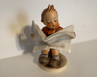 hummel boy reading newspaper