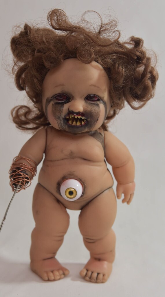 creepy baby teeth doll