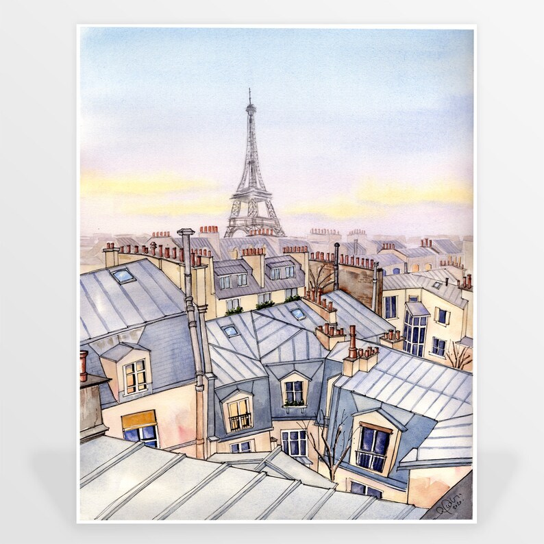May include: A watercolor painting of a Parisian cityscape with the Eiffel Tower in the background. The painting depicts a view from a rooftop, showing the rooftops of several buildings with chimneys and skylights. The sky is a soft blue with a hint of yellow in the distance.