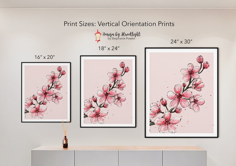 May include: Three framed prints of a pink cherry blossom branch on a pink background. The prints are in different sizes: 16" x 20", 18" x 24", and 24" x 30".