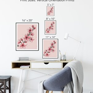 May include: A mockup of a pink watercolor painting of cherry blossoms in a black frame. The image shows different sizes of prints available: 5x7 inches, 8x10 inches, 11x14 inches, and 16x20 inches.