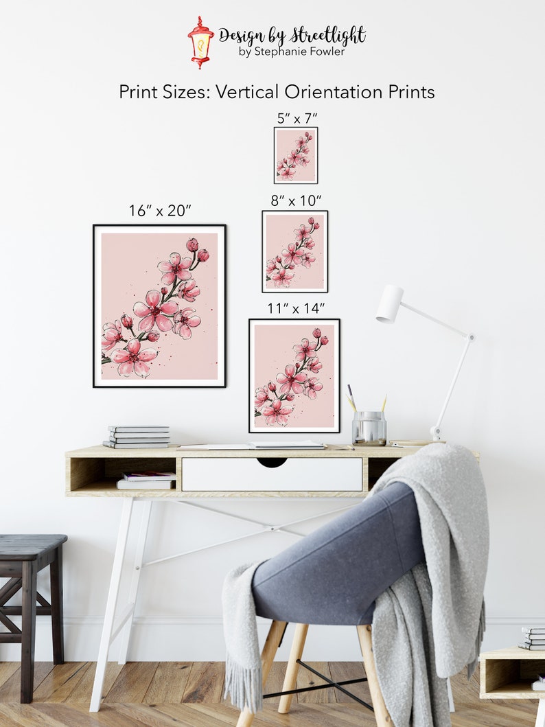May include: A mockup of a pink watercolor painting of cherry blossoms in a black frame. The image shows different sizes of prints available: 5x7 inches, 8x10 inches, 11x14 inches, and 16x20 inches.