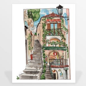 May include: A watercolor painting of a narrow, cobblestone street in a European city. The street is lined with buildings, and there are stairs leading up to a building with a green awning that says "Delikatessen".