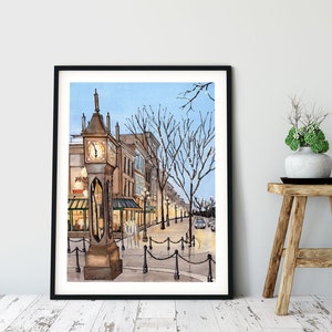 May include: Watercolour painting of a street scene with a clock tower in the foreground. The clock tower is brown with a white face and black hands. The street is lined with buildings and trees. The sky is blue and there are lights on the buildings.