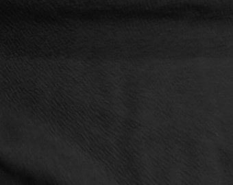 May include: Black fabric with a textured, slightly wrinkled surface.