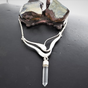 Precious crystal, cradled in sterling silver wings