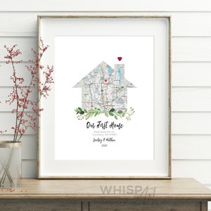 May include: A printable art print featuring a house-shaped map of a neighborhood with a red heart marking the location. The text "Our First Home" is below the map, along with an address, names, and the year 2020.