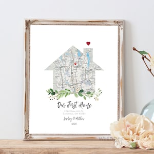 May include: A printable art print featuring a house-shaped map of Columbus, Ohio with a red heart on the chimney. The text "Our First Home" is below the map, along with the address, "9568 Slate Hill Ct., Columbus, OH 43085", and the names "Lindsey & Matthew" and the year "2020".