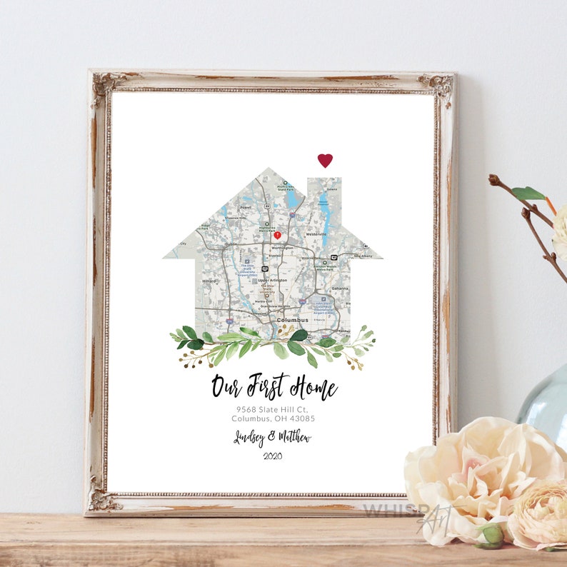 May include: A printable art print featuring a house-shaped map of Columbus, Ohio with a red heart on the chimney. The text "Our First Home" is below the map, along with the address, "9568 Slate Hill Ct., Columbus, OH 43085", and the names "Lindsey & Matthew" and the year "2020".