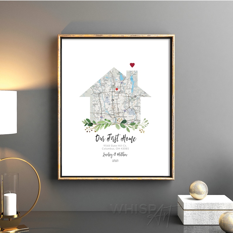 May include: A printable art print featuring a house-shaped map of a neighborhood with a red heart on the roof. The text "Our First Home" is below the map, along with the address, "9568 Slate Hill Ct, Columbus, OH 43085", the names "Luudsey & Matther", and the year "2020".