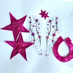 May include: A set of iron-on patches featuring a pink horseshoe, two pink stars, and two sheets of silver stars with pink accents.