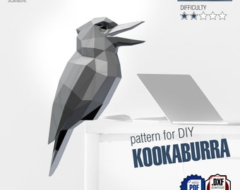 Może przedstawiać: Geometryczna, szara rzeźba kookaburry, przeznaczona do spawania metali DIY. Ptak ma około 68,7 cm wysokości i jest skalowalny. Obraz zawiera tekst "pattern for DIY KOOKABURRA" oraz ikony do pobierania PDF i DXF.