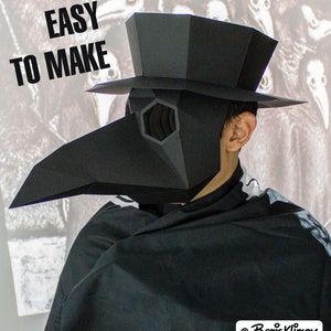 May include: A black papercraft plague doctor mask with a large beak and a tall hat. The mask has a hexagonal eye piece and the text "Easy to Make" is visible in the top left corner of the image.